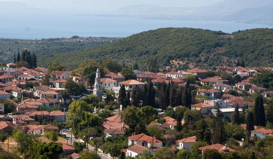 Drone view of Argalasti with the bell tower and the sea in the background